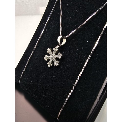 222 - An attractive as new 925 silver pendant necklace featuring a snowflake formed pendant, set with spar... 