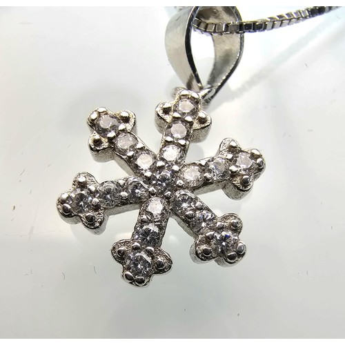 222 - An attractive as new 925 silver pendant necklace featuring a snowflake formed pendant, set with spar... 