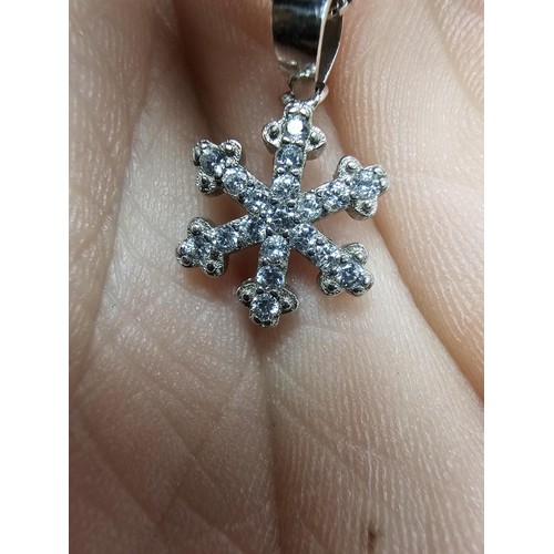 222 - An attractive as new 925 silver pendant necklace featuring a snowflake formed pendant, set with spar... 
