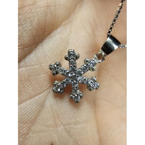 222 - An attractive as new 925 silver pendant necklace featuring a snowflake formed pendant, set with spar... 