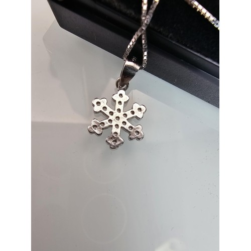 222 - An attractive as new 925 silver pendant necklace featuring a snowflake formed pendant, set with spar... 
