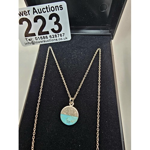 223 - A designer 925 silver pedant necklace by Oliver Bonas featuring a silver disk pendant, set with a tu... 