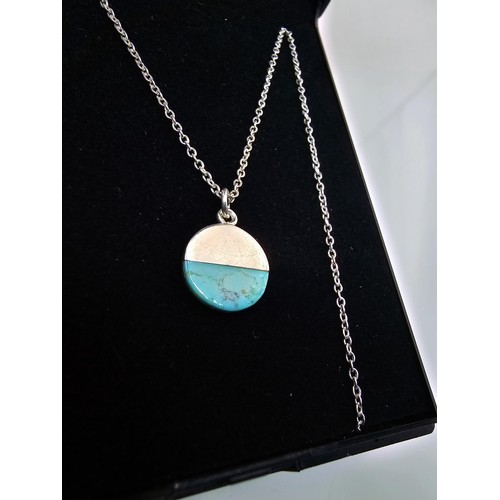223 - A designer 925 silver pedant necklace by Oliver Bonas featuring a silver disk pendant, set with a tu... 