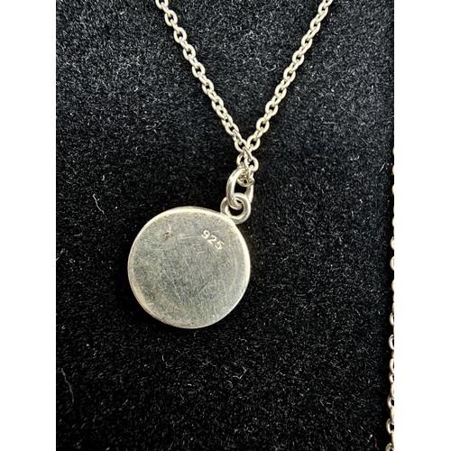 223 - A designer 925 silver pedant necklace by Oliver Bonas featuring a silver disk pendant, set with a tu... 
