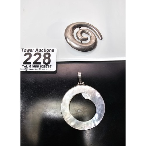228 - A large 925 silver spiral formed brooch in good order, along with a 925 silver mounted pendant, havi... 