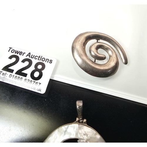 228 - A large 925 silver spiral formed brooch in good order, along with a 925 silver mounted pendant, havi... 