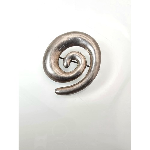 228 - A large 925 silver spiral formed brooch in good order, along with a 925 silver mounted pendant, havi... 
