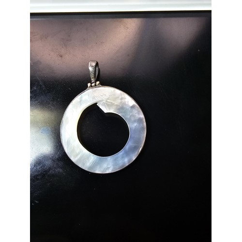 228 - A large 925 silver spiral formed brooch in good order, along with a 925 silver mounted pendant, havi... 