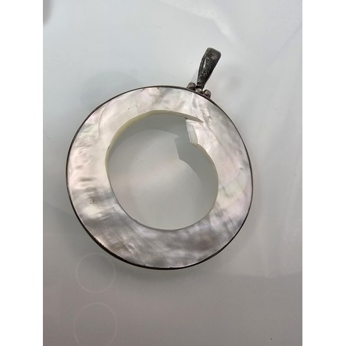 228 - A large 925 silver spiral formed brooch in good order, along with a 925 silver mounted pendant, havi... 
