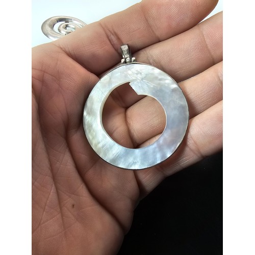 228 - A large 925 silver spiral formed brooch in good order, along with a 925 silver mounted pendant, havi... 