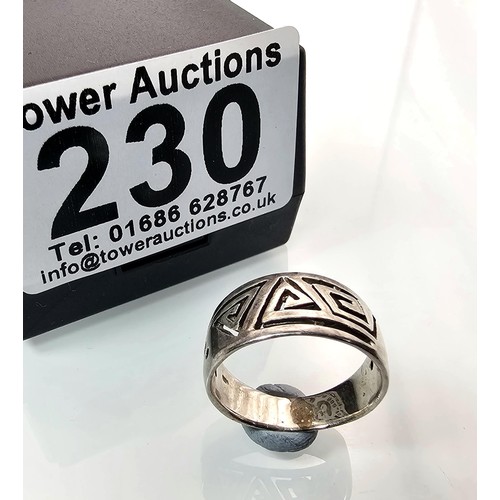 230 - A chunky 925 silver ring having an unusual pierced Aztec type design. The ring is in good clean cond... 