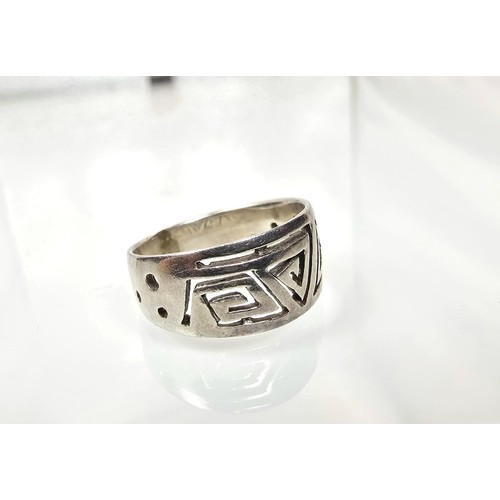 230 - A chunky 925 silver ring having an unusual pierced Aztec type design. The ring is in good clean cond... 