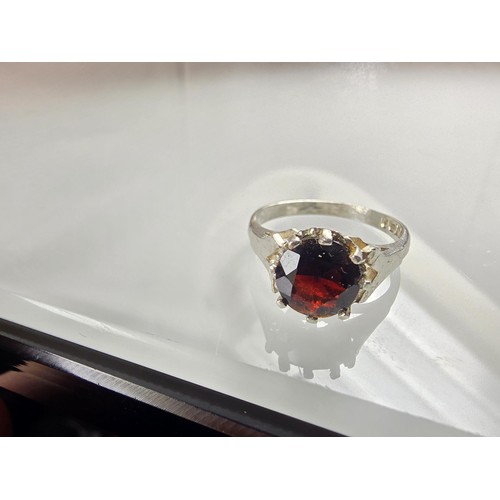 202 - A good quality vintage hallmarked silver solitaire ring set with a large round cut faceted garnet ge... 