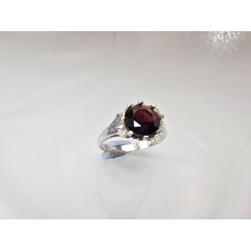 202 - A good quality vintage hallmarked silver solitaire ring set with a large round cut faceted garnet ge... 