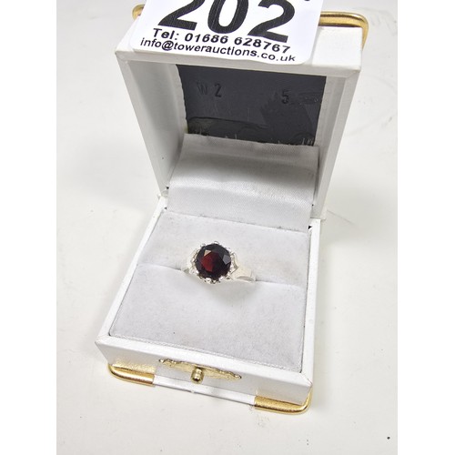 202 - A good quality vintage hallmarked silver solitaire ring set with a large round cut faceted garnet ge... 