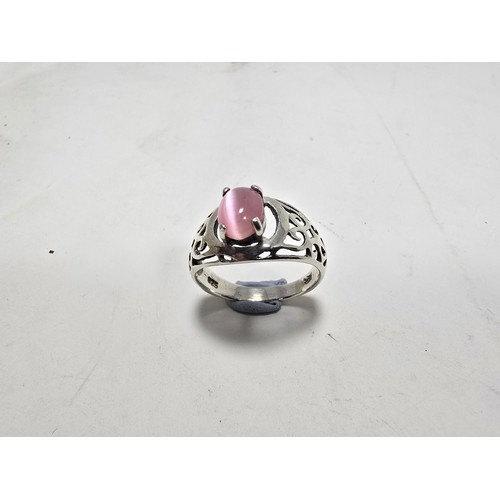 203 - An attractive 925 silver ring, having pierced shoulders, set with an attractive pink cats eye type c... 