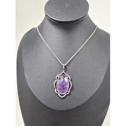 204 - A good quality 925 silver pendant necklace featuring a large silver pendant, set with a large oval f... 