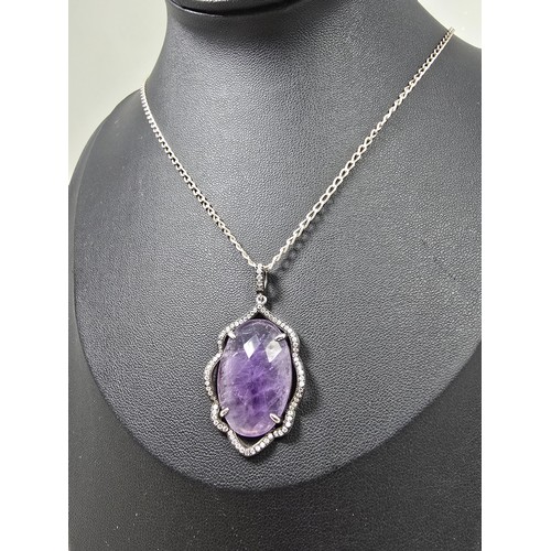 204 - A good quality 925 silver pendant necklace featuring a large silver pendant, set with a large oval f... 