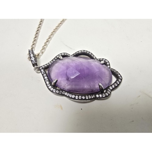 204 - A good quality 925 silver pendant necklace featuring a large silver pendant, set with a large oval f... 