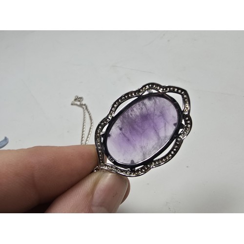 204 - A good quality 925 silver pendant necklace featuring a large silver pendant, set with a large oval f... 