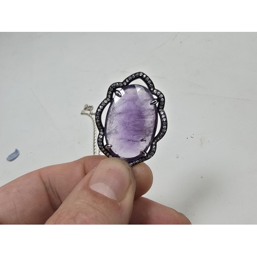 204 - A good quality 925 silver pendant necklace featuring a large silver pendant, set with a large oval f... 