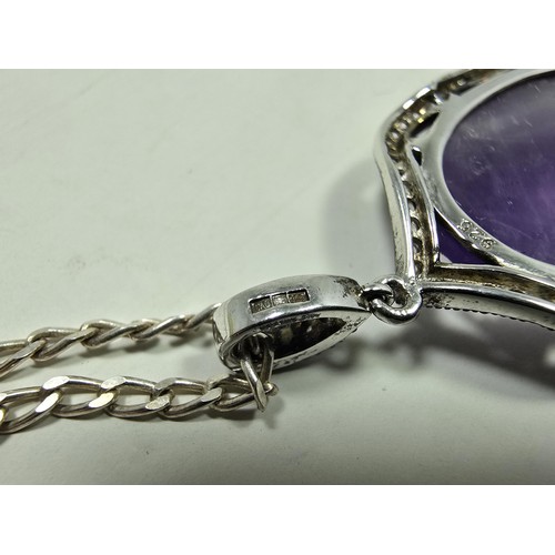 204 - A good quality 925 silver pendant necklace featuring a large silver pendant, set with a large oval f... 