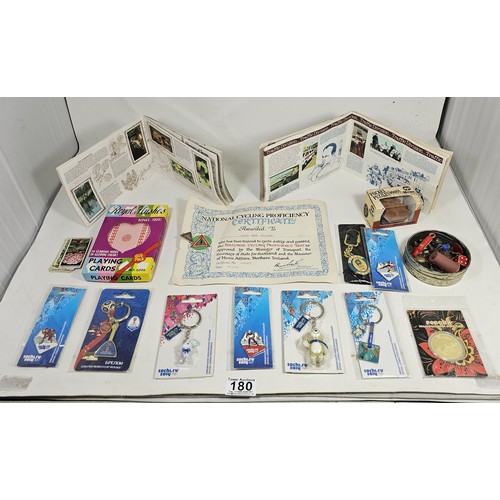 180 - A box of collectables, to include a quantity of 2018 Fifa World Cup Russia keyrings and pin badges, ... 