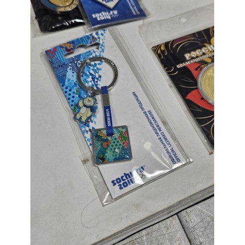 180 - A box of collectables, to include a quantity of 2018 Fifa World Cup Russia keyrings and pin badges, ... 