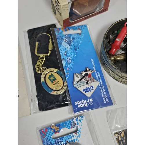 180 - A box of collectables, to include a quantity of 2018 Fifa World Cup Russia keyrings and pin badges, ... 