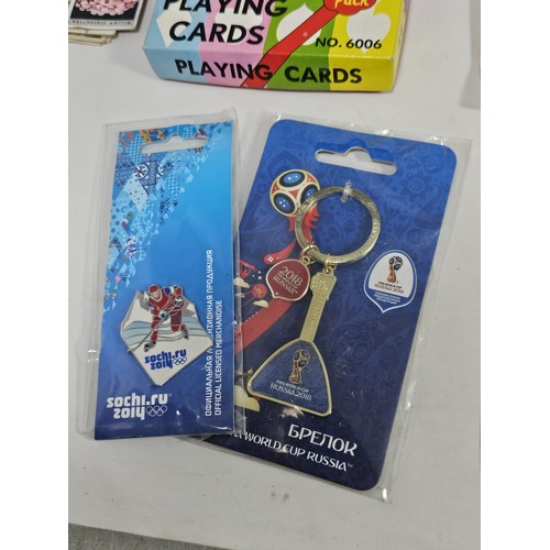 180 - A box of collectables, to include a quantity of 2018 Fifa World Cup Russia keyrings and pin badges, ... 