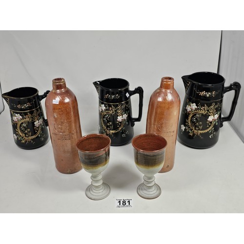 181 - A quantity of collectable ceramics, to include a set of 3 graduated handpainted black jugs, with a f... 