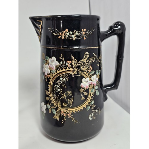 181 - A quantity of collectable ceramics, to include a set of 3 graduated handpainted black jugs, with a f... 