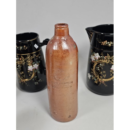 181 - A quantity of collectable ceramics, to include a set of 3 graduated handpainted black jugs, with a f... 
