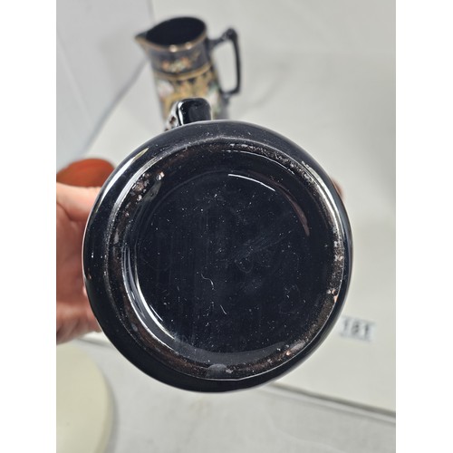 181 - A quantity of collectable ceramics, to include a set of 3 graduated handpainted black jugs, with a f... 
