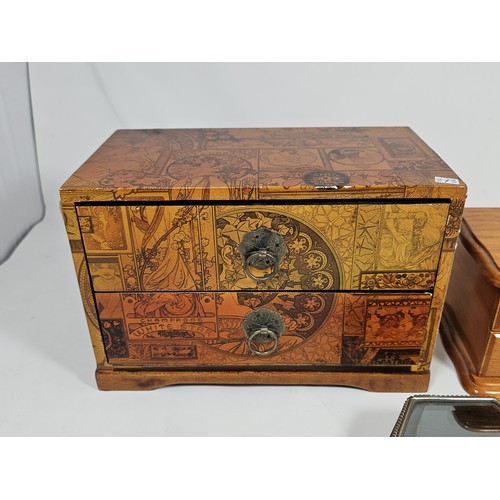 182 - A collection of 3 trinket boxes, to include a 2 drawer trinket box with a champagne design, a 2 draw... 