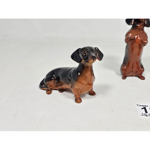 183 - A collection of 3 Beswick ceramic dachshund figurines, each modelled in characteristic poses with a ... 