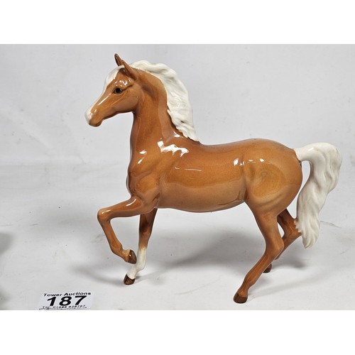 187 - A pair of Beswick horse figures, to include a Black Beauty figure in matte black with no chips or ol... 