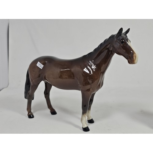 189 - A pair of Beswick Bay horses, 1 of the lighter coloured horses is stamped New Forest with an old rep... 