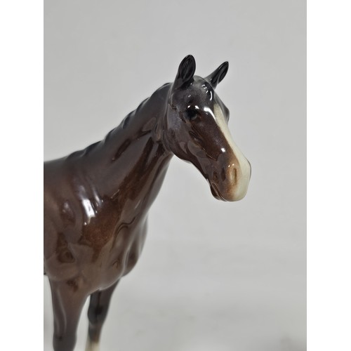 189 - A pair of Beswick Bay horses, 1 of the lighter coloured horses is stamped New Forest with an old rep... 