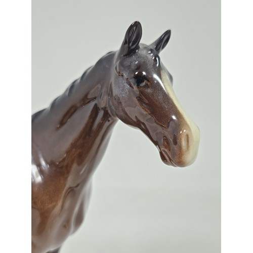 189 - A pair of Beswick Bay horses, 1 of the lighter coloured horses is stamped New Forest with an old rep... 