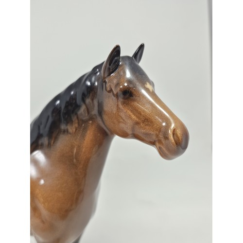 189 - A pair of Beswick Bay horses, 1 of the lighter coloured horses is stamped New Forest with an old rep... 