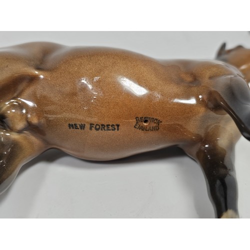 189 - A pair of Beswick Bay horses, 1 of the lighter coloured horses is stamped New Forest with an old rep... 