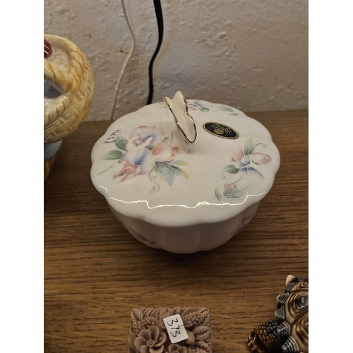 193 - A collection of collectable trinket boxes of varying makes and designs to include a wade trinket box... 
