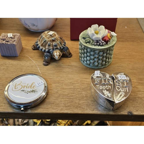 193 - A collection of collectable trinket boxes of varying makes and designs to include a wade trinket box... 