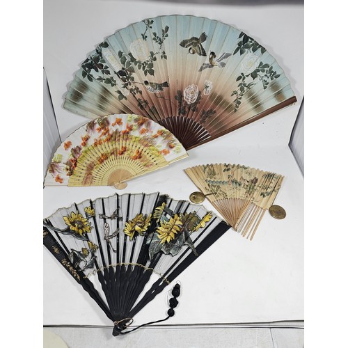 194 - A collection of 4x good quality oriental fans to include a black lace fan with hand stitched floral ... 