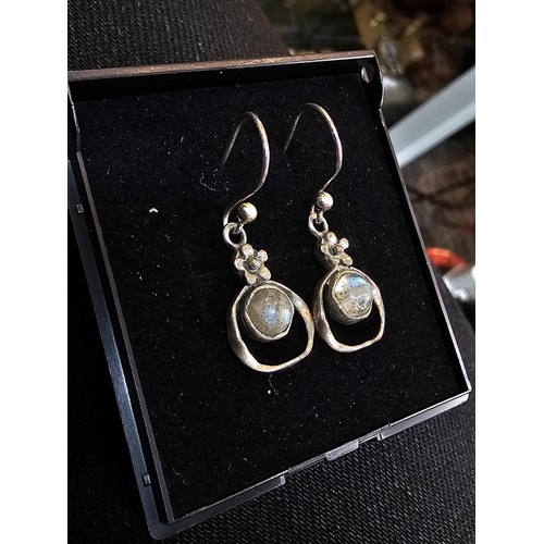 235 - A pair of pretty vintage 925 silver drop earrings, having a flower design set with rainbow moonstone... 