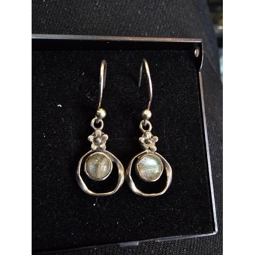 235 - A pair of pretty vintage 925 silver drop earrings, having a flower design set with rainbow moonstone... 