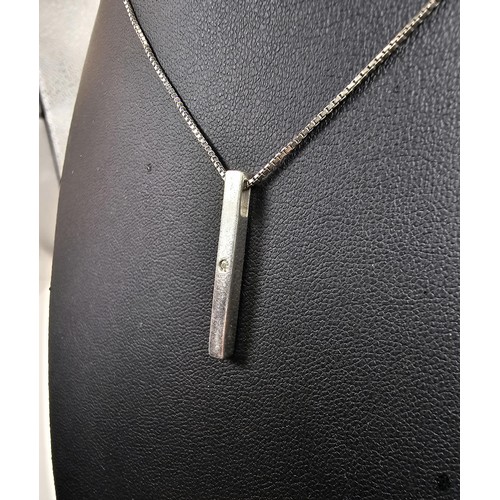 217 - A 925 silver pendant necklace featuring a bar formed silver pendant set with a real round cut diamon... 