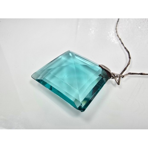 205 - A good quality 925 silver pendant necklace featuring a very large blue crystal glass faceted pendant... 