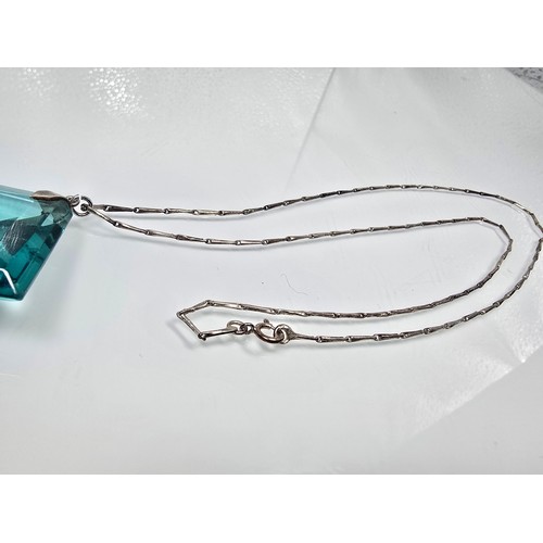 205 - A good quality 925 silver pendant necklace featuring a very large blue crystal glass faceted pendant... 